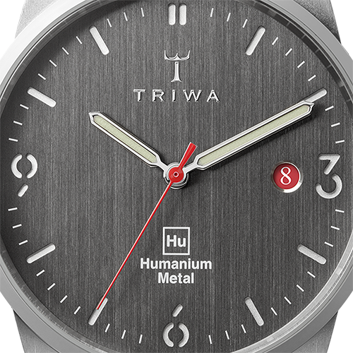Partial side view of Humanium metal watch by Triwa, black strap and dark grey dial. Sold at UNDP Shop