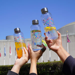 Image of three SDGs heart bottle in front of the United Nations Building in NYC